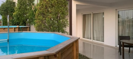 Suite with Round Wood Above Ground Pool